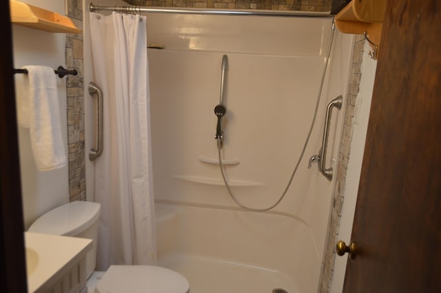 full bath with toilet and a shower stall