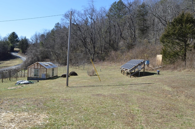 view of yard featuring an outbuilding and an exterior structure