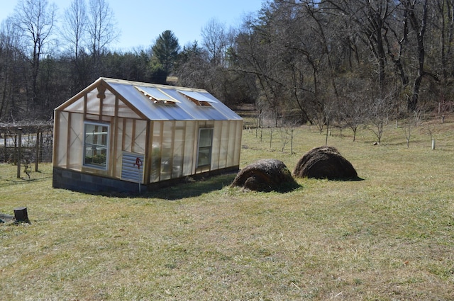 view of greenhouse featuring a lawn