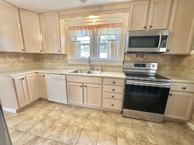 kitchen featuring stainless steel appliances, sink, and decorative backsplash