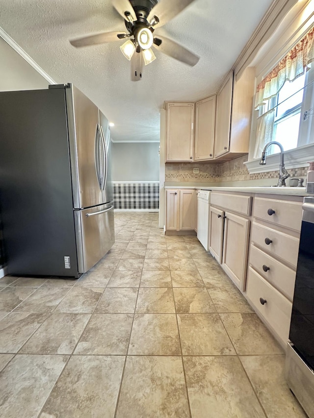 kitchen featuring stainless steel refrigerator, dishwasher, backsplash, ceiling fan, and a textured ceiling