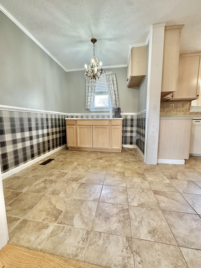 kitchen featuring crown molding, an inviting chandelier, hanging light fixtures, white dishwasher, and light brown cabinetry