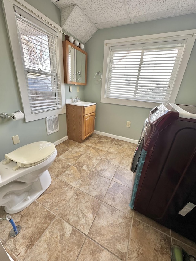 bathroom with vanity, a paneled ceiling, and toilet