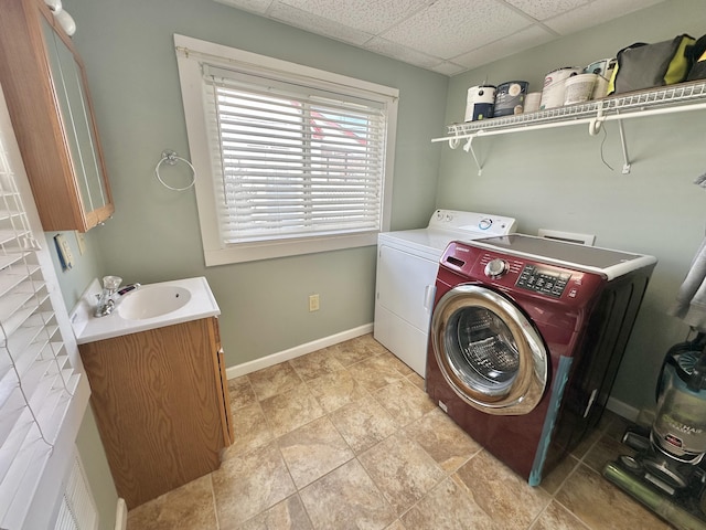 clothes washing area with sink and washing machine and clothes dryer