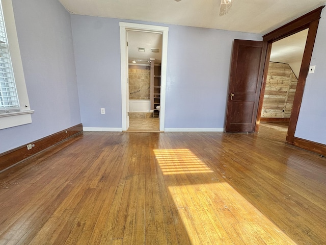 empty room featuring ceiling fan and hardwood / wood-style floors