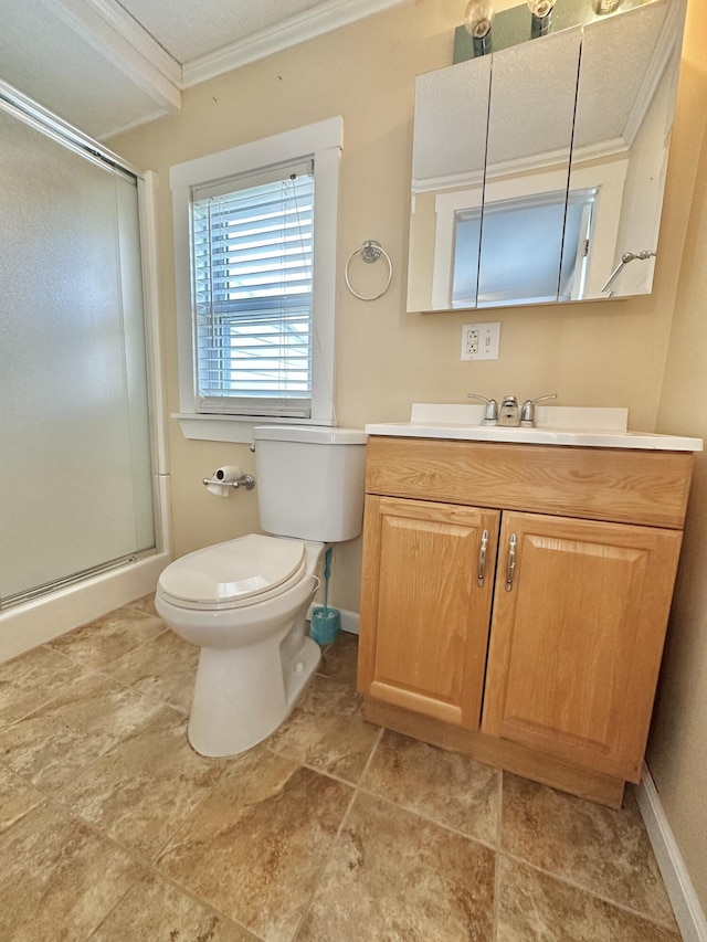 bathroom with crown molding, vanity, toilet, and a shower with door