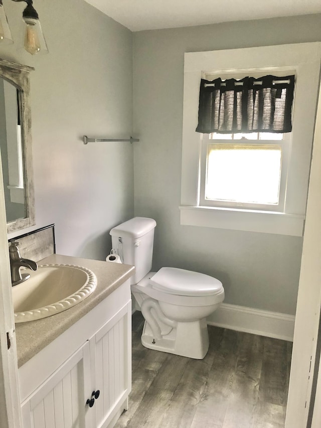 bathroom with vanity, hardwood / wood-style floors, and toilet