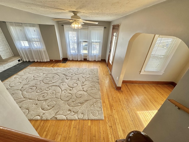 interior space with hardwood / wood-style floors, a textured ceiling, and ceiling fan