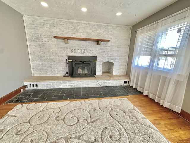 unfurnished living room with dark hardwood / wood-style floors and a textured ceiling