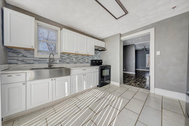 kitchen featuring tasteful backsplash, black range with electric stovetop, and white cabinets