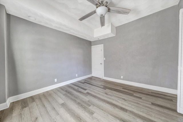 unfurnished room featuring ceiling fan and light wood-type flooring