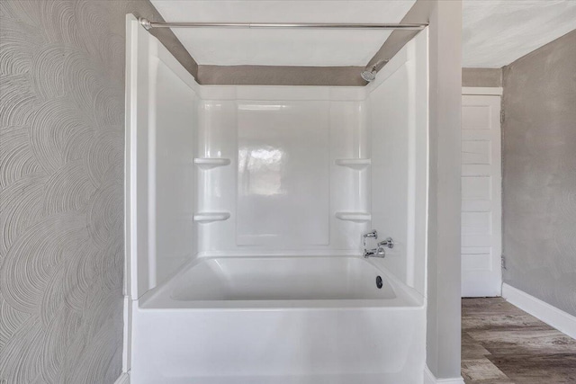 bathroom with hardwood / wood-style flooring and  shower combination