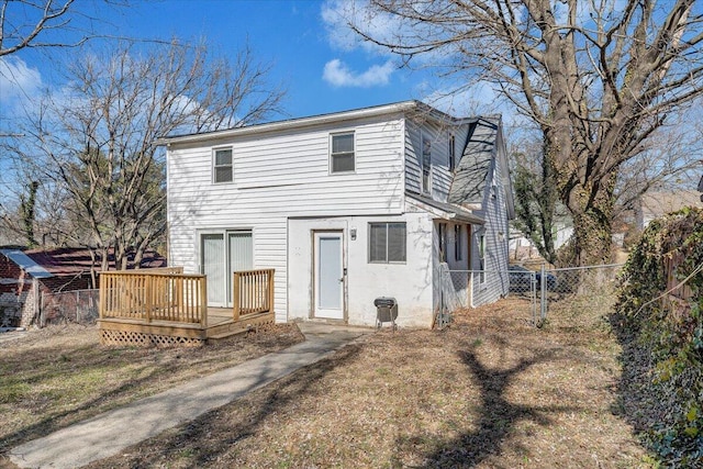 rear view of house featuring a deck