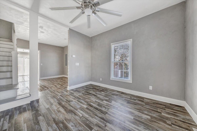 empty room with ceiling fan and dark hardwood / wood-style flooring