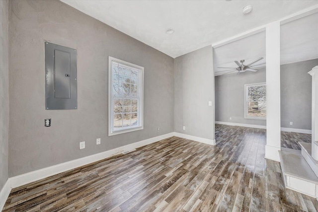 unfurnished room featuring wood-type flooring, electric panel, and ceiling fan