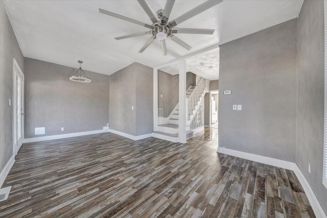 unfurnished living room featuring ceiling fan and dark hardwood / wood-style flooring