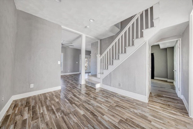 unfurnished living room with hardwood / wood-style floors and ceiling fan