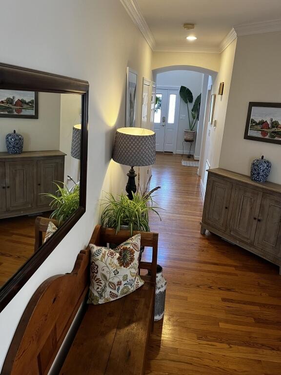 interior details with a warm lit fireplace and wood finished floors