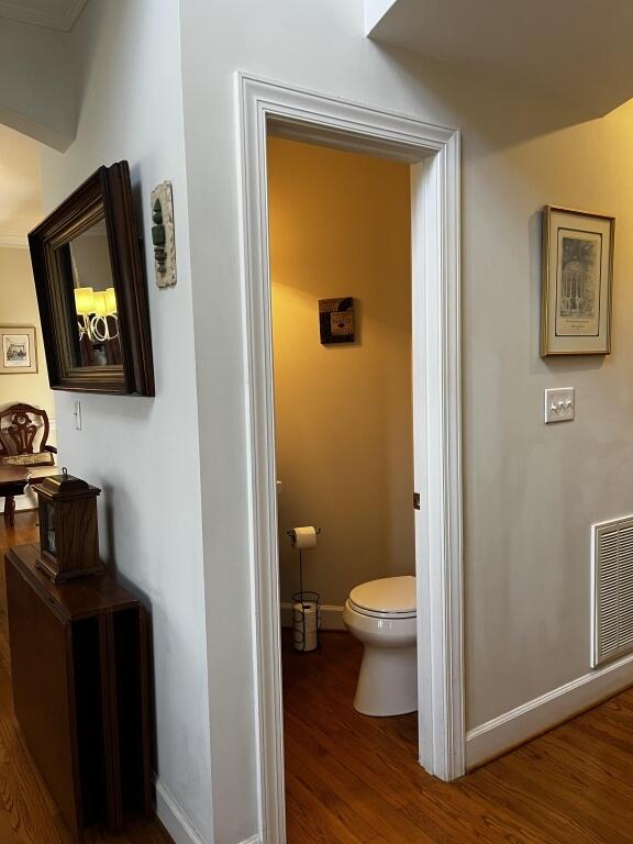 bathroom with hardwood / wood-style flooring and toilet