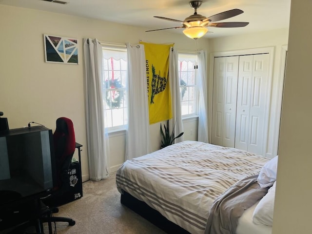 bedroom featuring ceiling fan, carpet floors, a closet, and visible vents