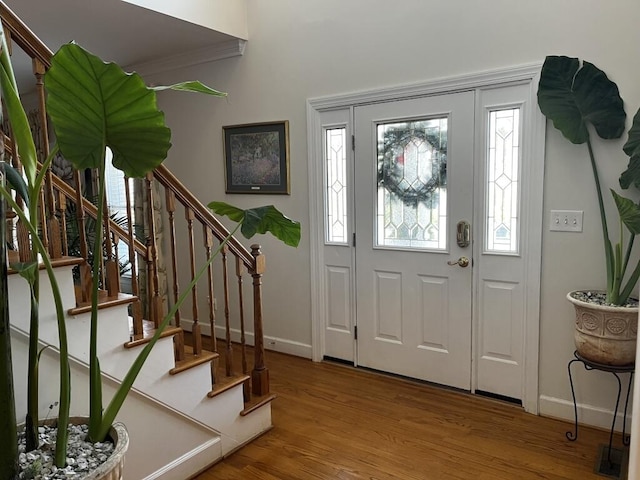 entrance foyer featuring baseboards, stairway, visible vents, and light wood-style floors