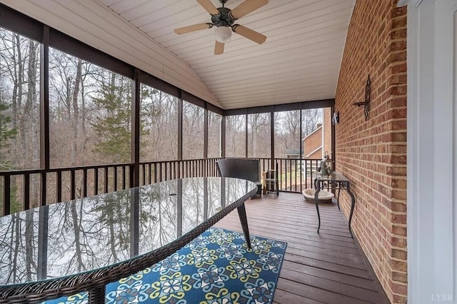 unfurnished sunroom with lofted ceiling and ceiling fan