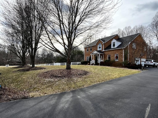 view of front of house featuring a front yard and brick siding