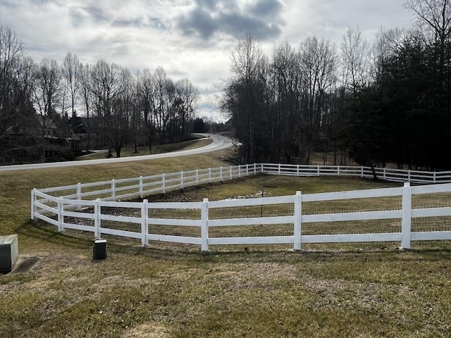 view of yard with a rural view and fence