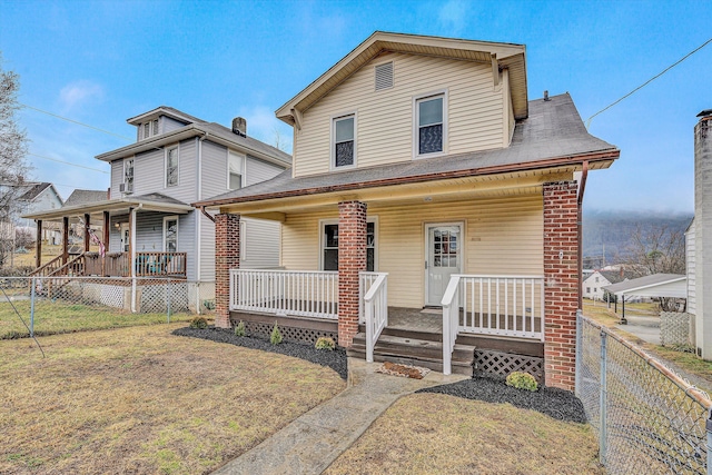 view of front facade with a front yard and covered porch