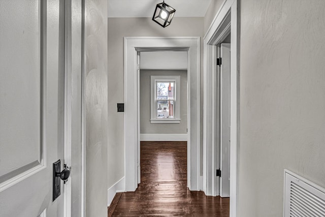 corridor with dark hardwood / wood-style flooring