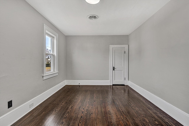 unfurnished room featuring dark hardwood / wood-style flooring