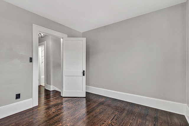 unfurnished room with dark hardwood / wood-style floors