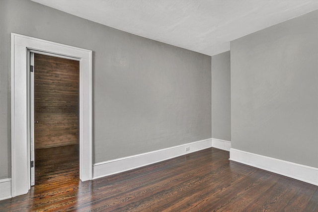 empty room with dark wood-type flooring