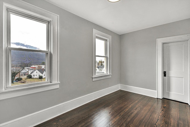 unfurnished room featuring dark hardwood / wood-style flooring