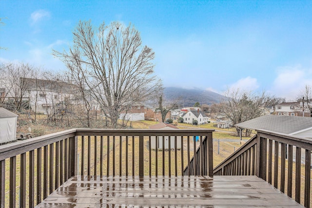 wooden deck featuring a lawn