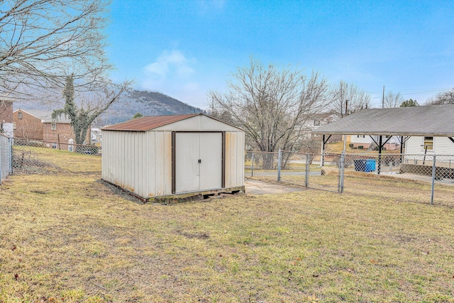 view of outdoor structure featuring a mountain view and a lawn