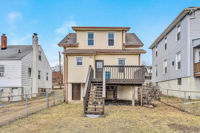 rear view of house featuring a yard and a deck