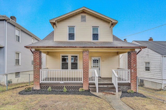 view of front of house featuring fence, a shingled roof, and covered porch