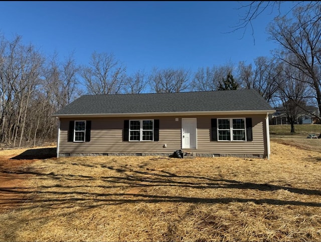 view of front of property with crawl space and roof with shingles