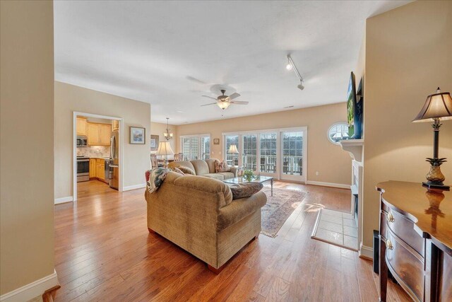 kitchen featuring wine cooler, appliances with stainless steel finishes, dark wood-type flooring, and light stone counters