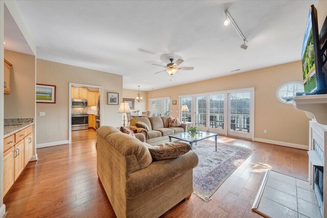 wooden deck with an outdoor hangout area and ceiling fan