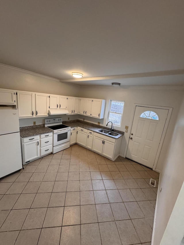 kitchen with sink, light tile patterned floors, white cabinets, and white appliances