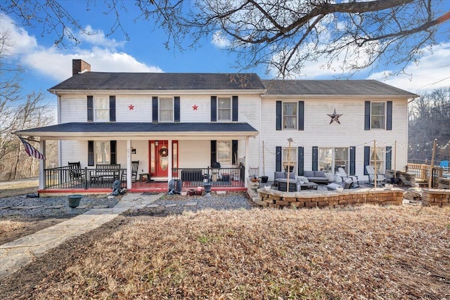 view of front of home with covered porch and a chimney