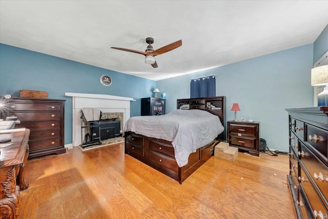 bedroom with ceiling fan and light hardwood / wood-style floors