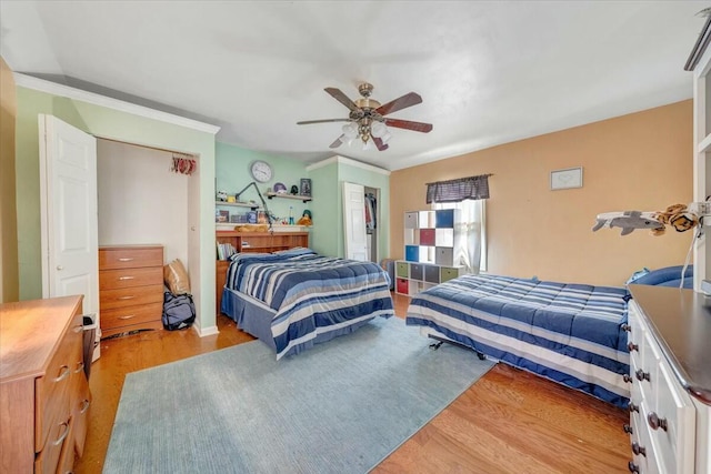 bedroom featuring ceiling fan, ornamental molding, and light hardwood / wood-style floors