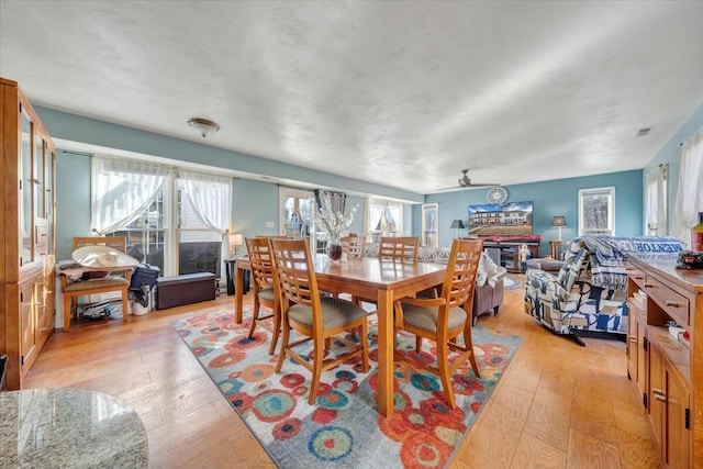 dining space featuring ceiling fan, a healthy amount of sunlight, and light wood-type flooring