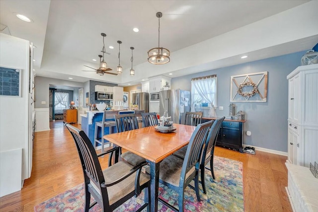 dining space featuring light hardwood / wood-style floors and ceiling fan