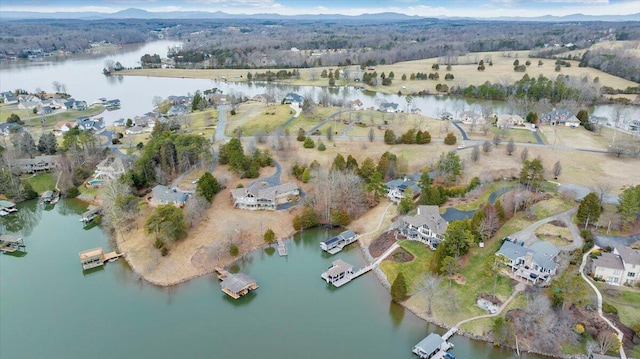 birds eye view of property featuring a view of trees and a water view