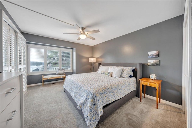 bedroom with baseboards, carpet, and a ceiling fan