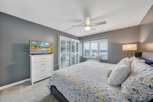 carpeted bedroom featuring a ceiling fan and baseboards